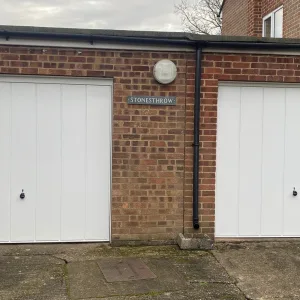 White Double Up & Over Garage Door with drainpipe